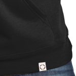 Black hoodie with woven label, close up view.